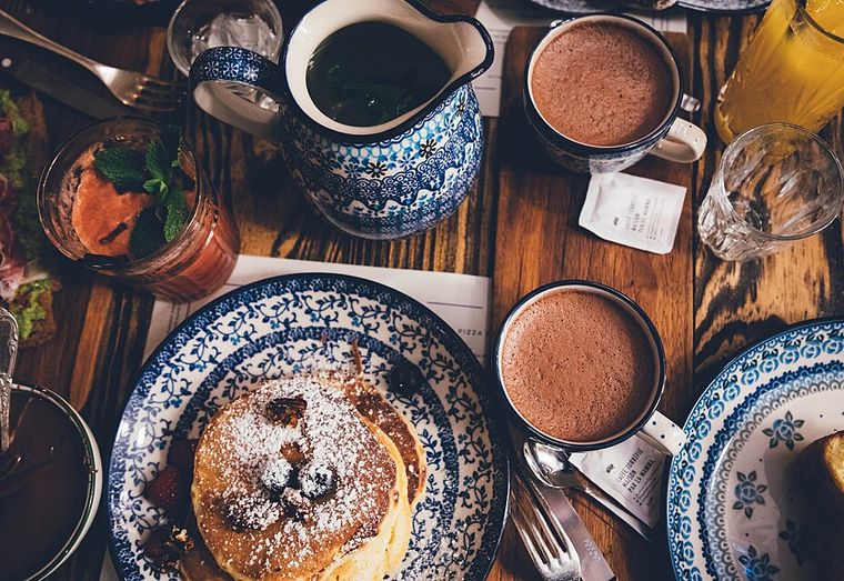 Brunch table with pancakes and hot chocolate shot straight down