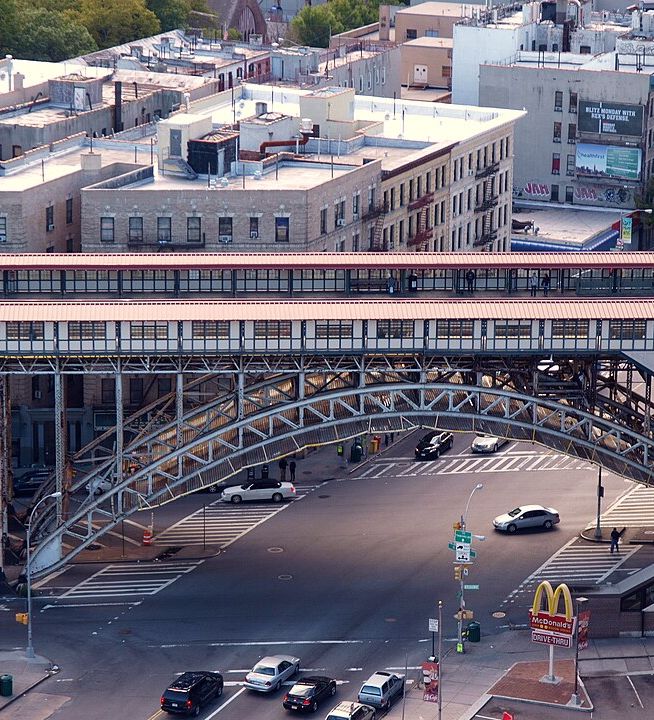 Street intersection under an elevated subway seen from directly above