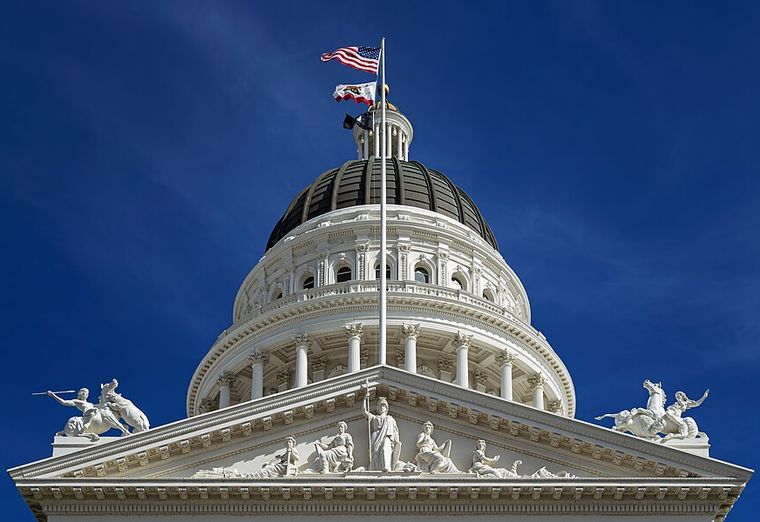 California State Capitol dome shot from below against deep blue sky