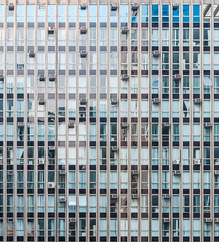Modernist facade shot perfectly square so the windows form a repeating pattern