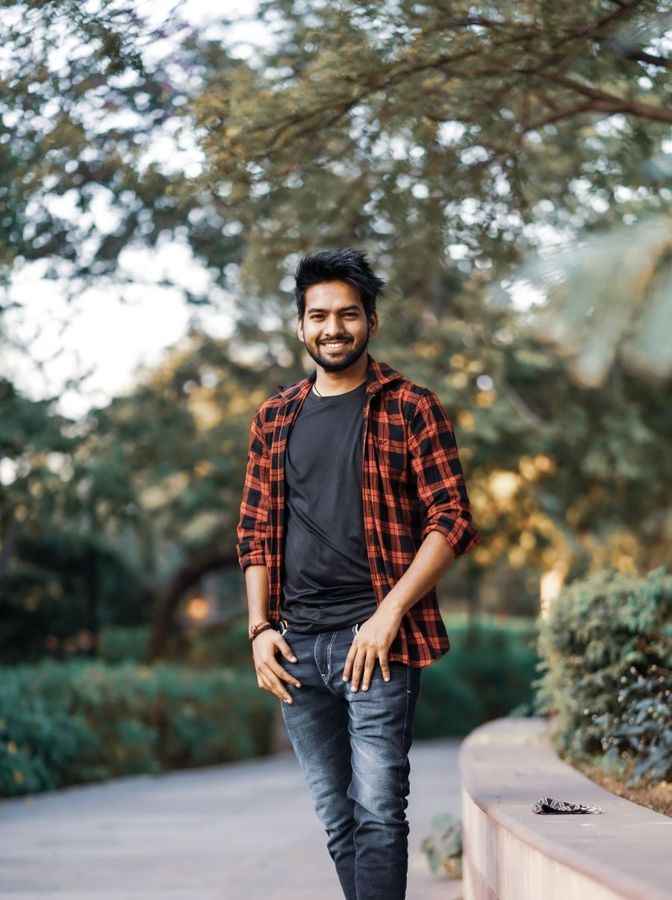 Man turned three-quarters to the camera with a relaxed genuine smile